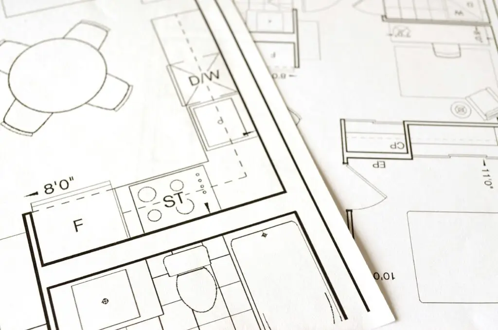 Architectural blueprint showing a kitchen, dining area, and bathroom layout with detailed measurements and labels